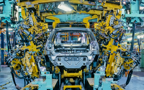 Car manufacturer producing car in assembly line.